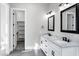 Modern bathroom with double vanity, large mirrors, and walk-in closet at 31559 N Pamela Dr, Queen Creek, AZ 85144