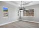 Bright dining room with large windows and a modern chandelier at 31559 N Pamela Dr, Queen Creek, AZ 85144