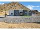 Modern two-tone home on a hillside lot with desert landscaping at 31559 N Pamela Dr, Queen Creek, AZ 85144