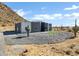 Modern house with gray and white exterior and mountain views at 31559 N Pamela Dr, Queen Creek, AZ 85144