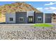 Modern desert home with neutral color scheme and mountain backdrop at 31559 N Pamela Dr, Queen Creek, AZ 85144