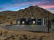 Contemporary home with desert landscaping and mountain backdrop at 31559 N Pamela Dr, Queen Creek, AZ 85144