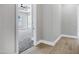 Light and bright hallway with wood-look flooring leading to a bedroom at 31559 N Pamela Dr, Queen Creek, AZ 85144