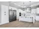 Modern white kitchen with stainless steel appliances and large island at 31559 N Pamela Dr, Queen Creek, AZ 85144