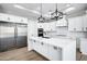 Modern kitchen with white cabinets, stainless steel appliances, and a large island at 31559 N Pamela Dr, Queen Creek, AZ 85144