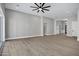 Spacious living room with wood-look floors and ceiling fan at 31559 N Pamela Dr, Queen Creek, AZ 85144