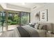 Bright bedroom with a sliding glass door offers seamless access to a private patio and garden at 7117 E Rancho Vista Dr # 4006, Scottsdale, AZ 85251