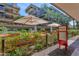 Outdoor dining area with umbrellas and lush landscaping at 7117 E Rancho Vista Dr # 4006, Scottsdale, AZ 85251