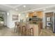 A well-lit kitchen features a granite countertop island, stainless steel appliances, and a washer-dryer combo for convenience at 7117 E Rancho Vista Dr # 4006, Scottsdale, AZ 85251