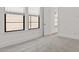Neutral toned bedroom featuring plush carpet flooring and two windows overlooking the home's exterior at 20306 W Turney Ave, Buckeye, AZ 85396