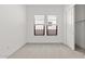 Neutral-toned bedroom featuring plush carpet flooring, two windows and sliding closet doors at 20306 W Turney Ave, Buckeye, AZ 85396
