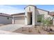Inviting single-Gathering home with a beige stucco exterior, tile roof, desert landscaping, and a paved driveway at 20306 W Turney Ave, Buckeye, AZ 85396