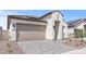 Inviting single-Gathering home with a beige stucco exterior, a tile roof, and a paved driveway at 20306 W Turney Ave, Buckeye, AZ 85396