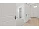 Bright hallway featuring white walls, wooden floors, and sliding barn door leading to an adjoining bedroom at 20306 W Turney Ave, Buckeye, AZ 85396