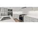 Modern kitchen with white cabinets, stainless steel appliances, white subway tile backsplash, and a gas range at 20306 W Turney Ave, Buckeye, AZ 85396