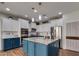 Modern kitchen with blue cabinets, granite island, and stainless steel appliances at 20747 W Alsap Rd, Buckeye, AZ 85396