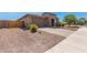 Single-story home with stone accents, two-car garage, and landscaped front yard at 18465 W Fulton St, Goodyear, AZ 85338