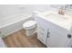 Bright bathroom with a white vanity, quartz countertop, and a bathtub with shower at 2428 W Rowel Rd, Phoenix, AZ 85085