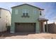 Two-story home featuring a two-car garage, charming porch, and low maintenance desert landscaping at 2428 W Rowel Rd, Phoenix, AZ 85085