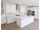 Beautiful kitchen with white cabinets, quartz countertops, a large island, and stainless steel appliances at 2428 W Rowel Rd, Phoenix, AZ 85085