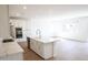Open kitchen layout with a large island, quartz countertops, and stainless steel appliances at 2428 W Rowel Rd, Phoenix, AZ 85085