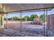 View of a backyard with desert landscaping from under a covered porch at 10619 W Clair Dr, Sun City, AZ 85351