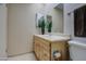 Bathroom featuring a light wood vanity, mirror, and tiled floor at 10619 W Clair Dr, Sun City, AZ 85351