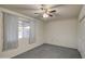 Bedroom featuring a ceiling fan, closet, and window with sheer curtains at 10619 W Clair Dr, Sun City, AZ 85351
