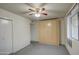 Bedroom featuring a ceiling fan, closet, window with curtains, and built in wardrobe at 10619 W Clair Dr, Sun City, AZ 85351