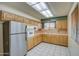 Spacious kitchen with stainless steel refrigerator and generous cabinet storage at 10619 W Clair Dr, Sun City, AZ 85351