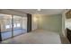 Cozy living area with access to a sunroom, neutral color scheme, and plush carpeting at 10619 W Clair Dr, Sun City, AZ 85351