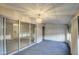 Sun room featuring a tiled floor, windows, and ceiling fan with light fixture at 10619 W Clair Dr, Sun City, AZ 85351