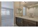 Bathroom featuring a double sink vanity, large mirror and walk-in shower at 31969 N 117Th Ave, Peoria, AZ 85383