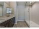 Bathroom featuring a double sink vanity, large mirror and walk-in shower at 31969 N 117Th Ave, Peoria, AZ 85383
