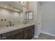 Bathroom featuring a double sink vanity, large mirror and walk-in shower at 31969 N 117Th Ave, Peoria, AZ 85383