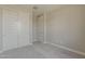 Bedroom with a double door closet, plush neutral carpet and base moulding at 31969 N 117Th Ave, Peoria, AZ 85383
