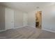 Bedroom with carpet, two doors, and a view of the bathroom at 31969 N 117Th Ave, Peoria, AZ 85383