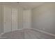 Bedroom with a double door closet, plush neutral carpet and base moulding at 31969 N 117Th Ave, Peoria, AZ 85383