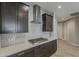 Well-appointed kitchen with stainless steel hood, stylish gas cooktop, sleek countertops, and cabinets at 31969 N 117Th Ave, Peoria, AZ 85383