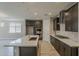 Modern kitchen with large island, stainless steel appliances, dark cabinets, and plenty of countertop space at 31969 N 117Th Ave, Peoria, AZ 85383