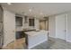 Large kitchen features dark wood cabinets, stainless appliances, center island, and open layout at 31969 N 117Th Ave, Peoria, AZ 85383