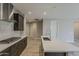 Spacious open kitchen with dark cabinets, light countertops, modern appliances, and a large island at 31969 N 117Th Ave, Peoria, AZ 85383