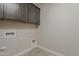 Laundry room with upper storage cabinets and tile floors, ready for appliances at 31969 N 117Th Ave, Peoria, AZ 85383