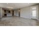 Open-concept living room with tile floors and a view of the modern kitchen at 31969 N 117Th Ave, Peoria, AZ 85383