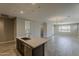 Open-concept living area with neutral walls, tile flooring, recessed lighting, and a view of the backyard at 31969 N 117Th Ave, Peoria, AZ 85383