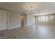 Spacious living room featuring tile floors, natural light, and a decorative chandelier at 31969 N 117Th Ave, Peoria, AZ 85383