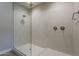 Walk-in shower featuring beautiful tile work, rainfall shower head and a glass enclosure at 31969 N 117Th Ave, Peoria, AZ 85383