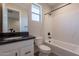Modern bathroom with white cabinets, granite countertop, and bathtub-shower combo at 31985 N 117Th Ave, Peoria, AZ 85383