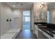 Modern bathroom with walk-in shower and dual sinks with granite countertops and modern fixtures at 31985 N 117Th Ave, Peoria, AZ 85383