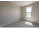 Bright, carpeted bedroom with a large window providing natural light at 31985 N 117Th Ave, Peoria, AZ 85383